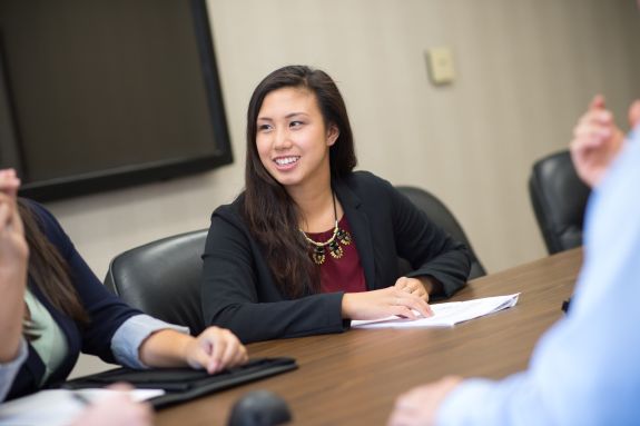 Graduate business students work together to design a funding proposal 