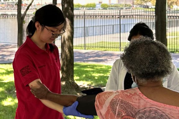 Student with patient at health fair