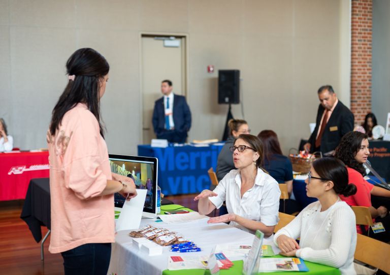 student interacts with employers at career fair