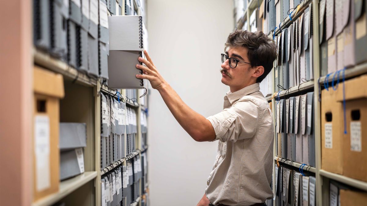 A student looks through material in the Pacific archives.