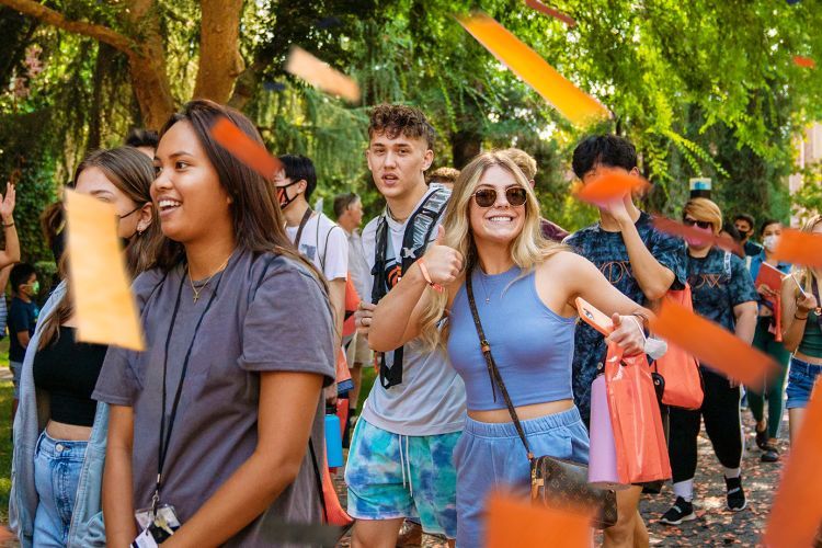 Students walk through a confetti parade during the Week of Welcome.