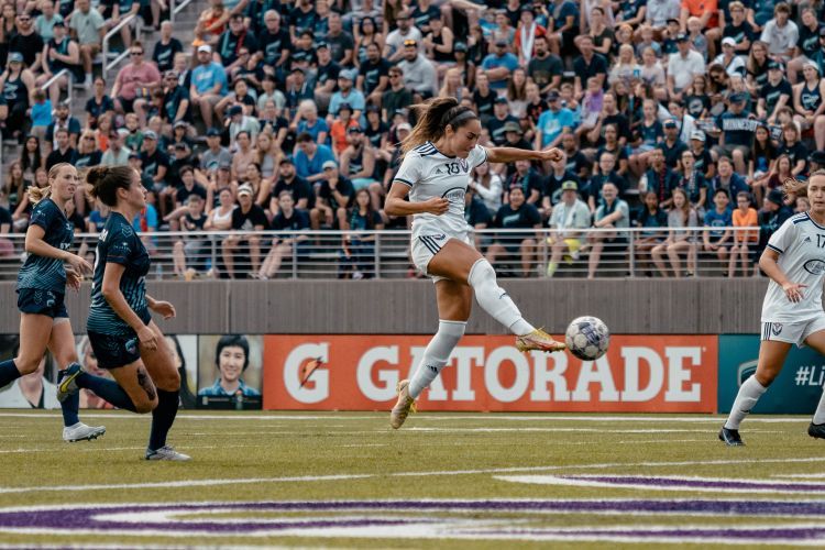 Three soccer players compete in championship game.