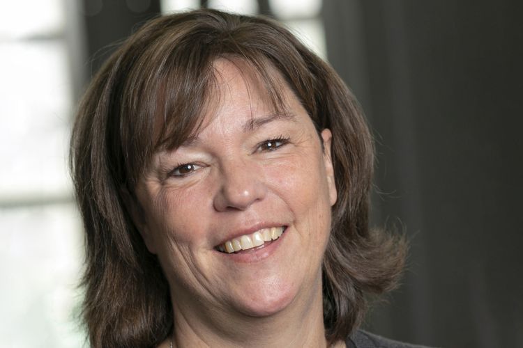 A close-up headshot of a female professor