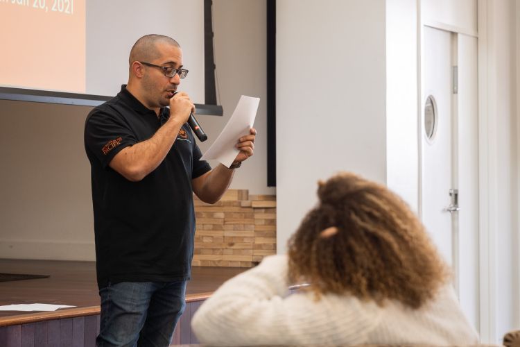 a student reads a speech during an event for MLK day