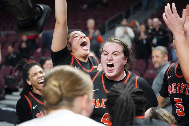 women's team celebrates their win on the court