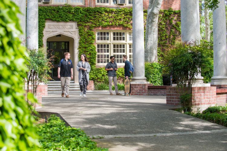 students standing next to the columns on the Pacific campus