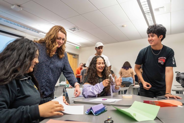 students sit at a table 