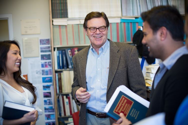 Stephen McCaffrey photographed smiling with law students.