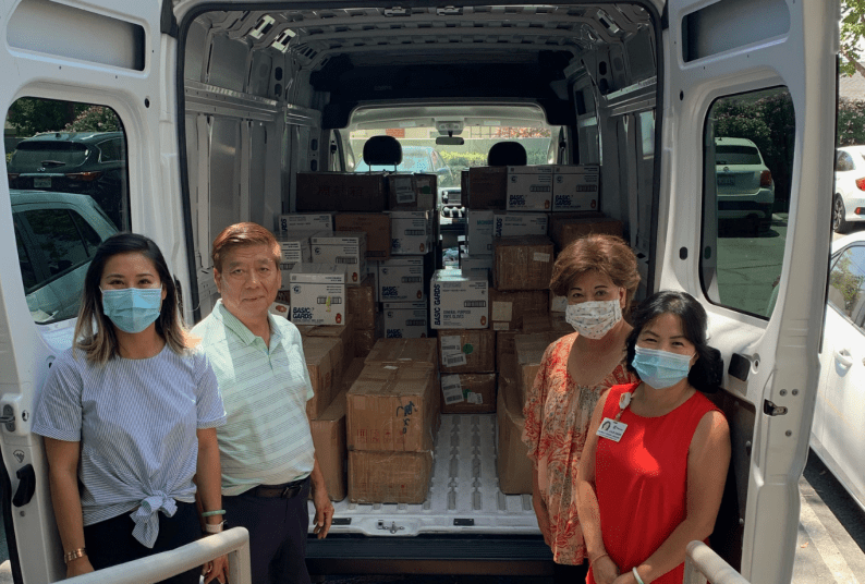 The Chan family next to van full of PPE