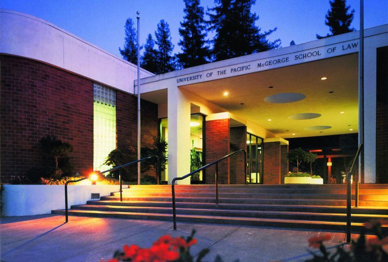 The front of McGeorge School of Law lit up during a Sacramento evening.