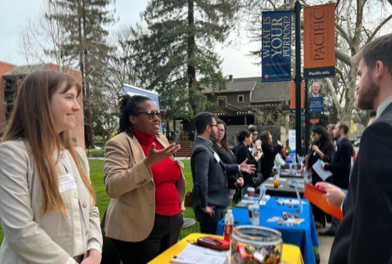 A handful of employers talk to students at a career fair