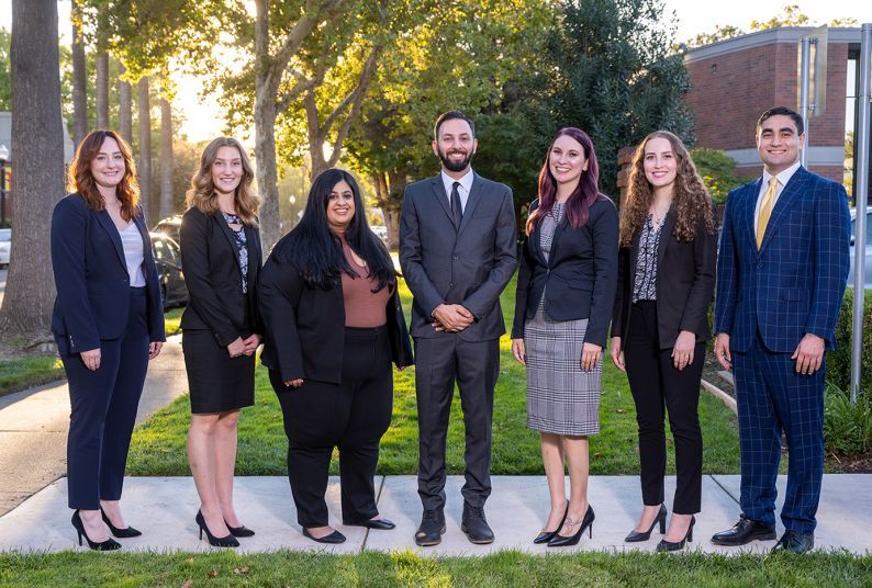 A group photo of 7 students in suits