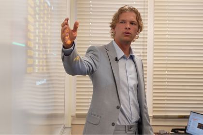 a student points to a whiteboard