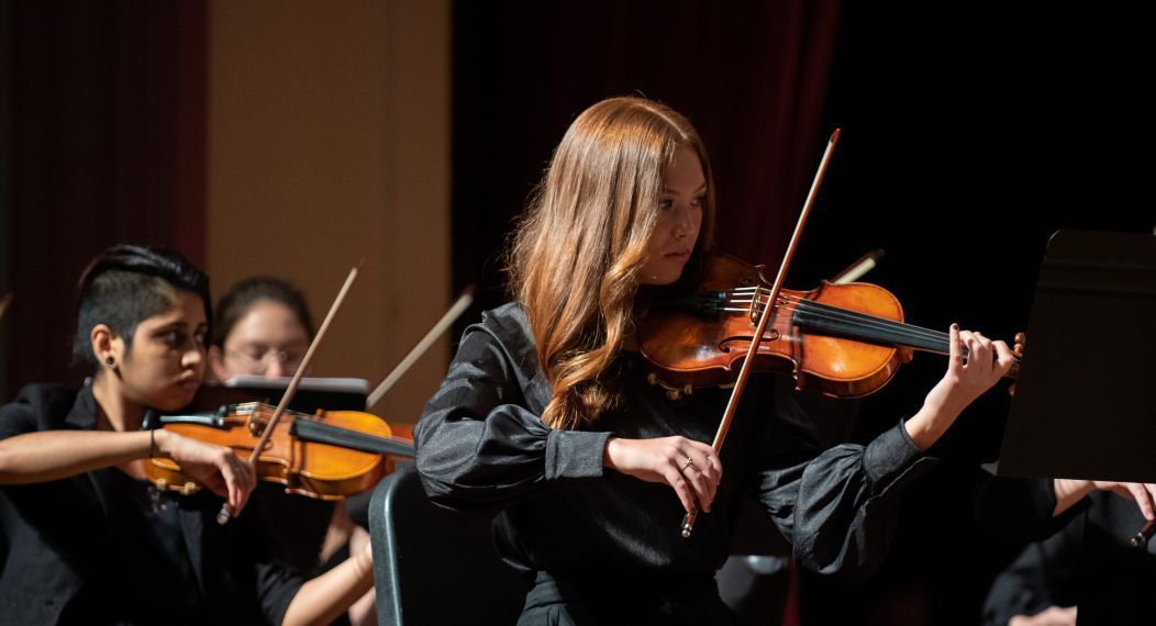 a woman plays the violin