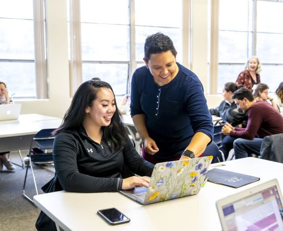 student and professor interacting in classroom