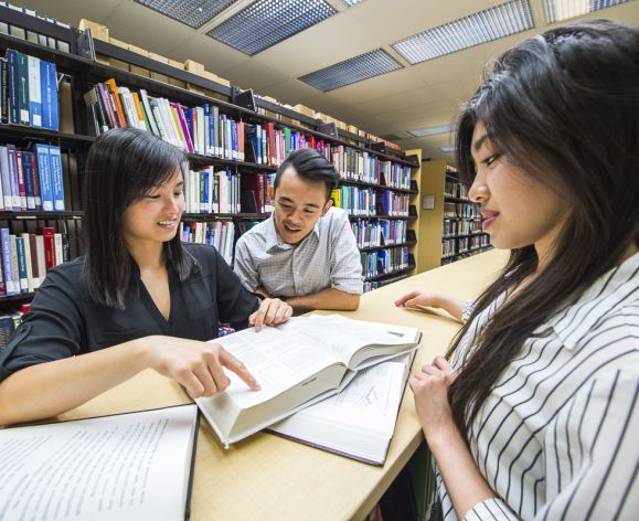 Pharmacy students studying in the library