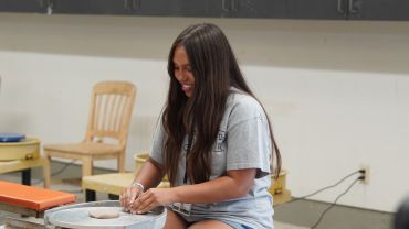 Ceramics students working with clay